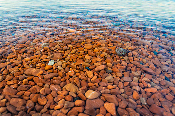 Captivating view of colored rocks and clear waters at Ionas Beach along the shore of Lake Superior