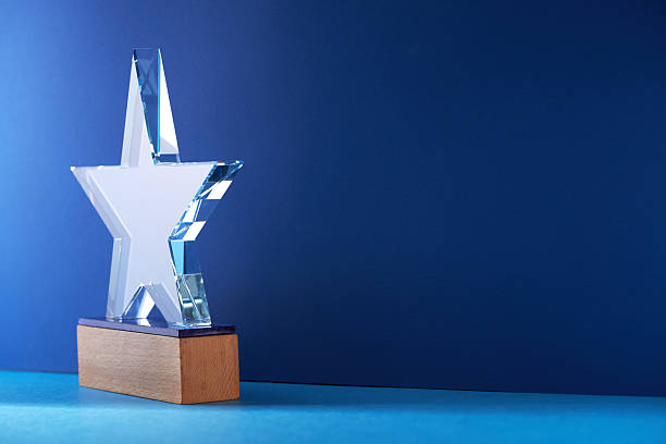 istock crystal trophy against blue background. 2223151078