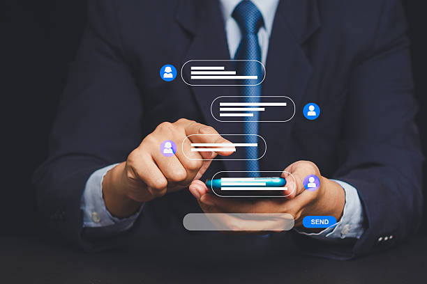 istock Businessman texting on smartphone with floating chat bubbles, concept of mobile communication. 2223151279