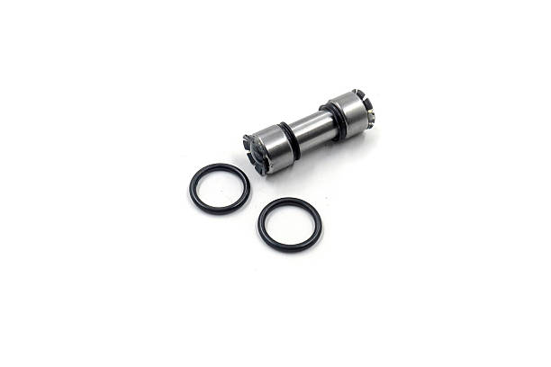 istock a metallic, cylindrical component, mechanical shaft or cam, with serrated or geared ends. A black, elastic band or O-ring is wrapped around its central smooth section. 2223153171