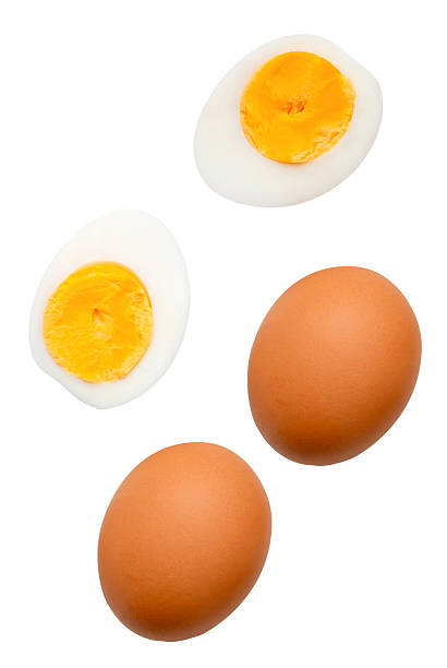 istock Top view set of two raw chicken eggs and cooked or boiled egg with egg yolk in two halves isolated on white background with clipping path 2223153418