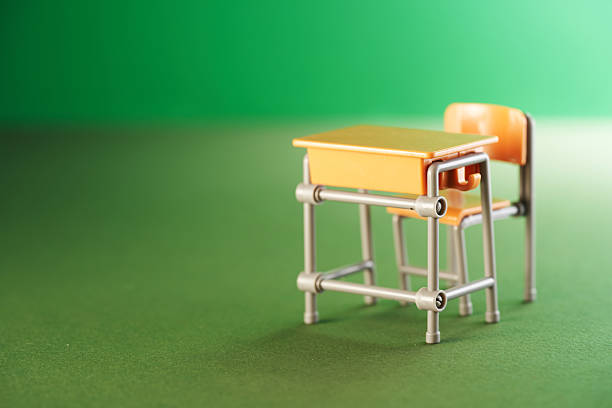 toy classroom desks against green background