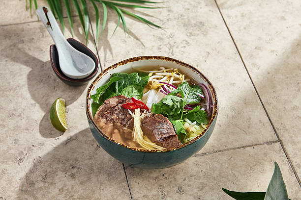 istock Pho bo soup with beef, herbs, moody sunlight, ceramic bowl, overhead composition 2223155842