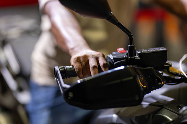 Close-up of man hand on motorcycle handlebars