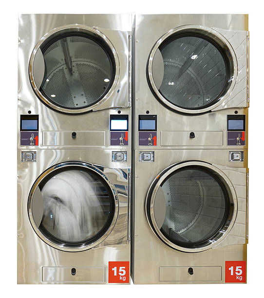 Qualified coin operated laundry machine in the public room to wash  cloths. Concept of a self service commercial laundry and drying machine in a public room. Coin operated Laundry Machines.
