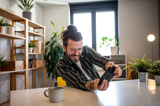 istock Enthusiastic designer playing video games during work break at home office 2223158356