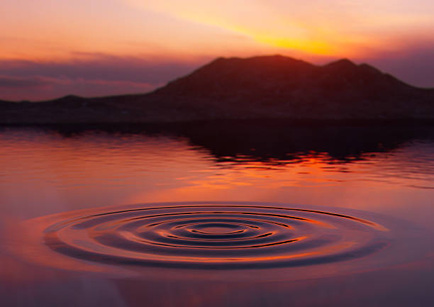 istock Sunrise Over Smooth Water With Ripple Stage 2223159775