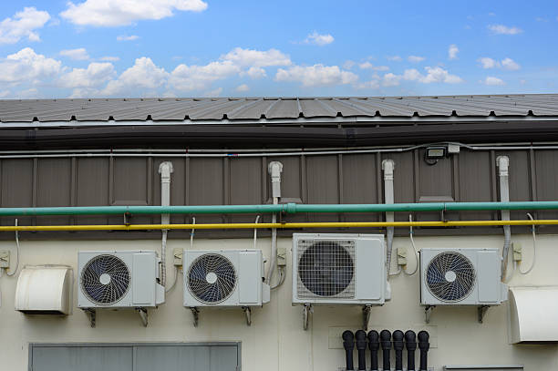 istock Air compressor or air condenser unit located on support outside building to heat released transferred to surrounding environment, Compressor is part of cooling function and air conditioning 2223163825