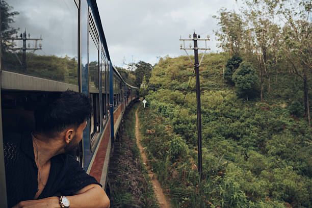 istock Young man looking out of a train window in Sri Lanka 2223164355