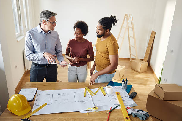 istock Male architect and black couple using touchpad during home renovation process. 2223165718