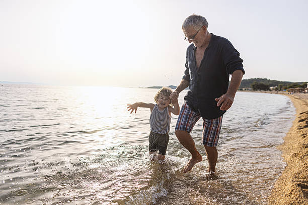 istock Running throught the waves with my Grandpa 2223171209