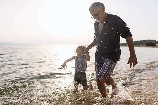 istock Running throught the waves with my Grandpa 2223171320