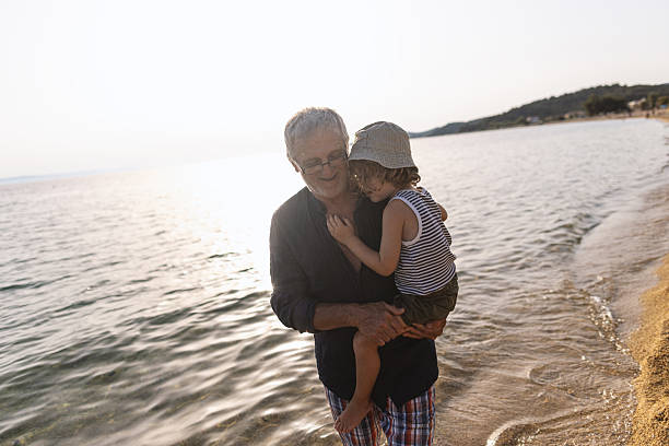 istock Grandfather and Grandson at the beach 2223172357