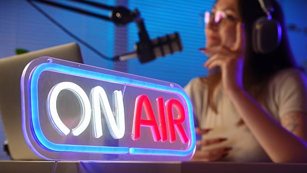istock Podcast Studio with Host and On Air Neon Sign 2223172705