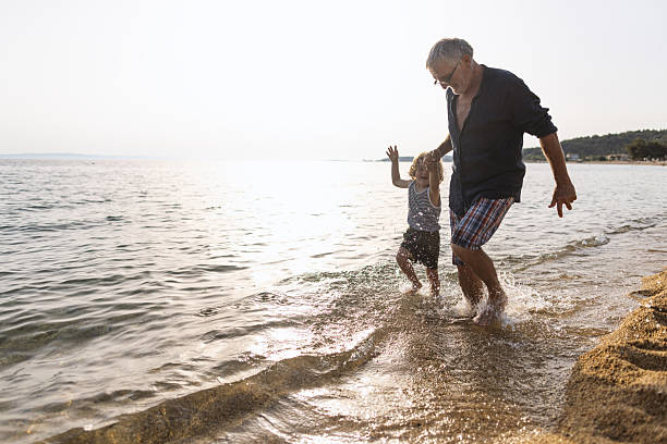 istock Running throught the waves with my Grandpa 2223172844