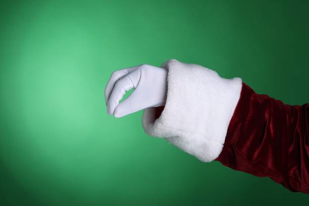 istock Santa Claus holding something on green background, closeup. Space for text 2223173217