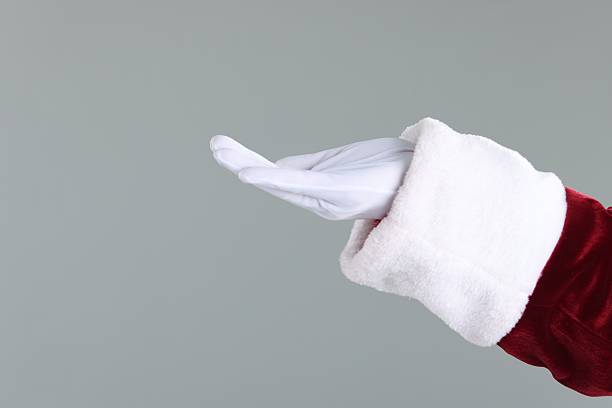 istock Santa Claus holding something on gray background, closeup. Space for text 2223173219