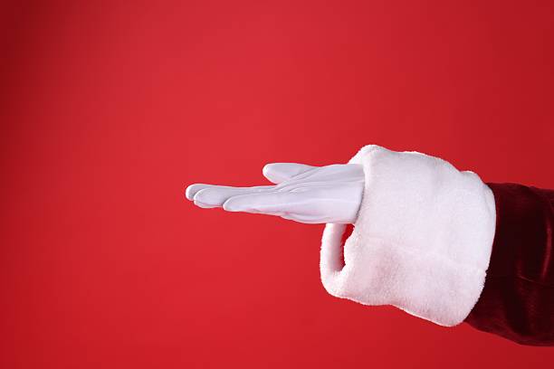 istock Santa Claus holding something on red background, closeup. Space for text 2223173349