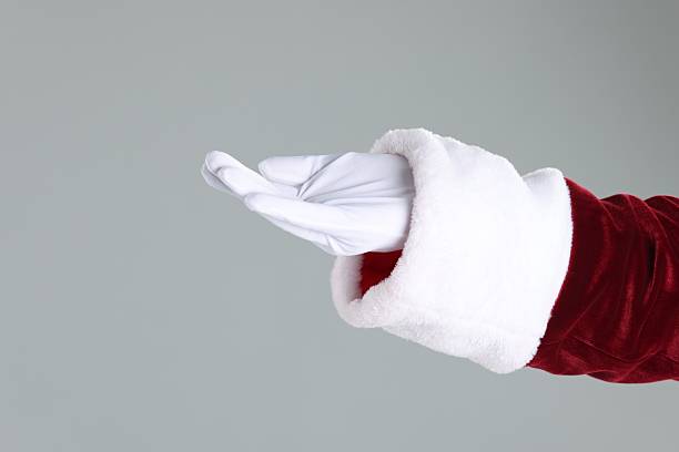 istock Santa Claus holding something on gray background, closeup. Space for text 2223173414