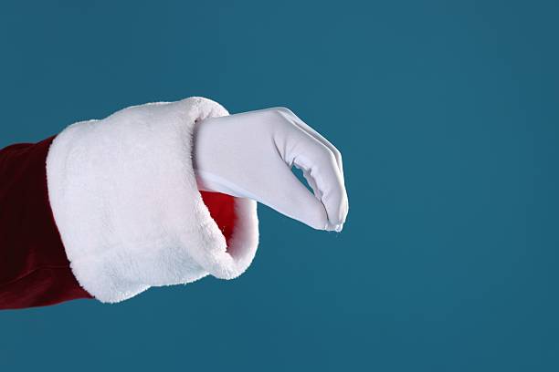 istock Santa Claus holding something on blue background, closeup. Space for text 2223173422