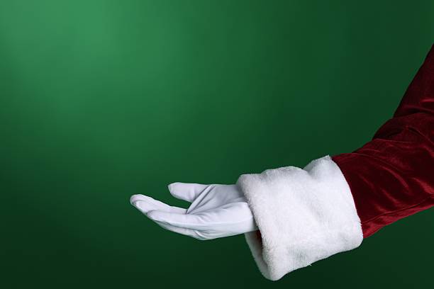 istock Santa Claus holding something on green background, closeup. Space for text 2223173464