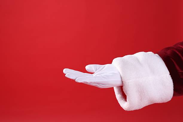 istock Santa Claus holding something on red background, closeup. Space for text 2223173490