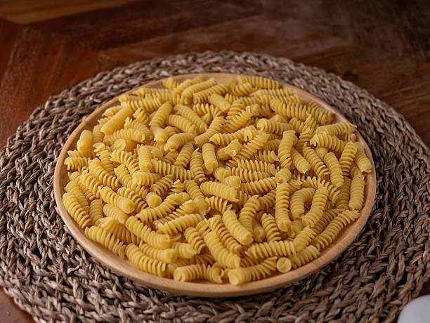 Raw Fusilli Spiral spaghetti pasta pattern background.