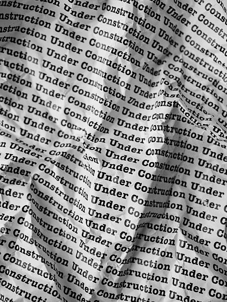 istock Words Under Construction Seamless print on crumpled paper for business background. 2223173635