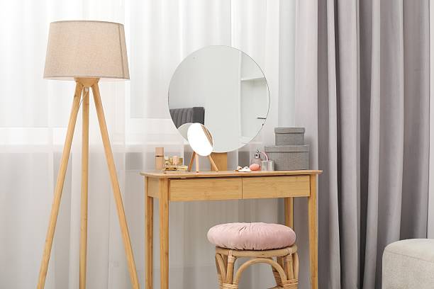 istock Mirror, dressing table, lamp and stool near window indoors. Interior design 2223173643