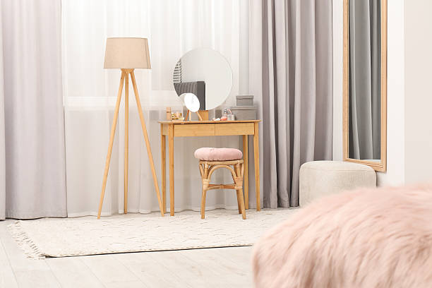 istock Mirrors, dressing table, lamp and stool near window indoors. Interior design 2223173724