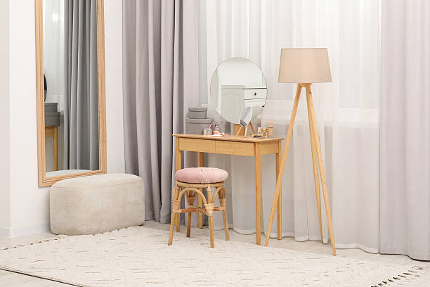 istock Mirrors, dressing table, lamp and stool near window indoors. Interior design 2223173730