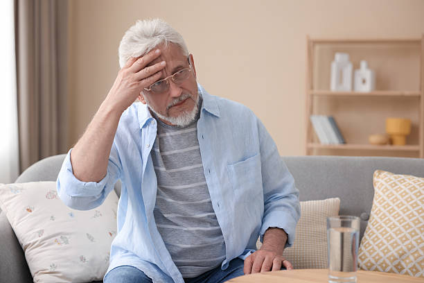 istock Senior man suffering from headache at home 2223173999