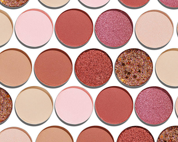 istock Colorful Swatches eyeshadow refills as minimal geometric pattern. Matte and glitter pans red brown pink shade with sun shadows, detail texture, cosmetic, beauty product, makeup, warm color scheme 2223174469