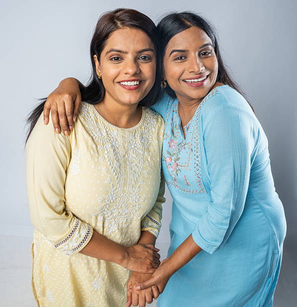 istock Female friends smiling and standing on white background 2223174692