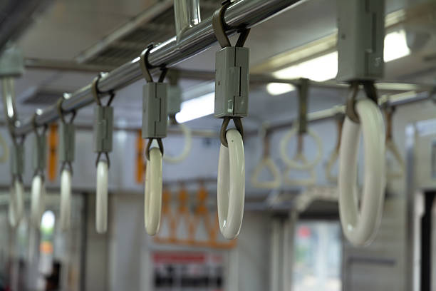 Close-up image of a handle grip or hand hanger on a commuter train, symbolizing the essential role of public transportation in supporting daily urban mobility. The photo highlights a clean and orderly transit environment, emphasizing efficient and well-maintained infrastructure. Ideal for illustrating themes related to urban planning, daily commute, public safety, and sustainable city transportation.