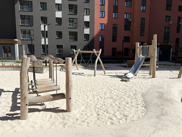 istock Modern playground with natural wood structures and soft sand surface in residential area, designed for safe and eco-friendly children activities in a calm and secure environment 2223175464
