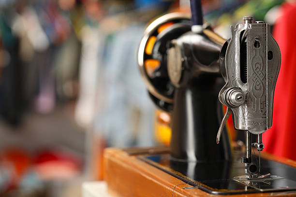 One vintage sewing machine in workshop, closeup. Space for text