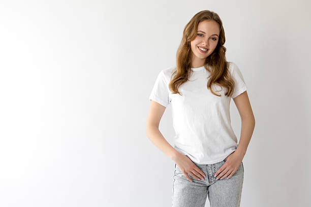 istock Young and beautiful woman posing with hands in pockets 2223175982