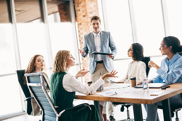 istock Young professionals collaborating during a business meeting in modern office setting, showcasing teamwork and corporate interaction 2223176398