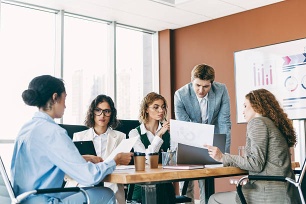 istock Group of business professionals collaborating on a project in a modern office setting with formal attire and teamwork 2223176455