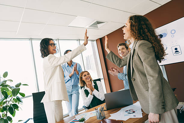 istock Team celebrating success with high-five in professional office setting showcasing collaboration and positive teamwork. 2223176485