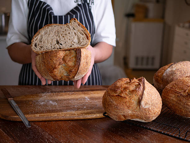 istock Baker's Hand Presenting Homemade Sourdough. 2223177438