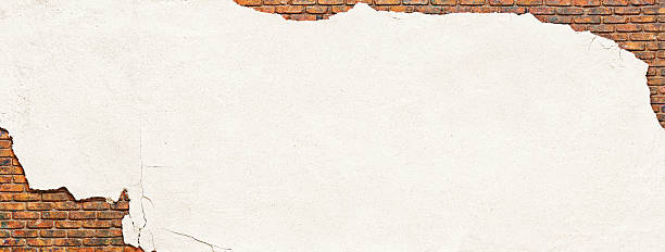 istock brick wall covered with crumbling plaster, peeling white stucco 2223179549