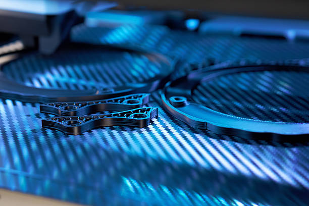 istock 3D Printer Produces Intricate Components on a Blue-Lit Work Surface With Carbon Fiber Textures 2223180230
