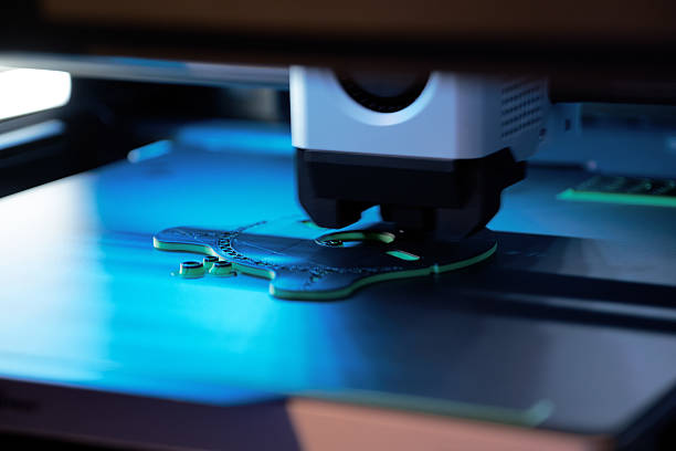istock 3D Printer in Action Creating a Detailed Object With Green Filament in a Modern Workspace 2223180241