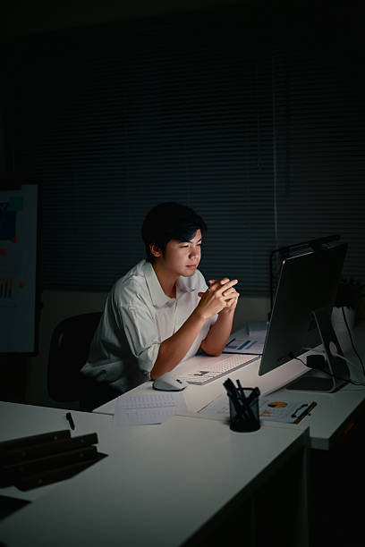 istock Serious entrepreneur concentrating on tasks during overtime 2223180535