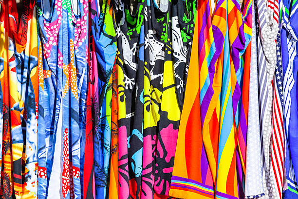 A fabric with colorful flowers and leaves in a close up view