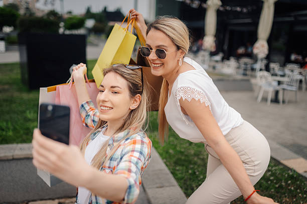 istock Two happy women taking selfie after shopping spree 2223184409