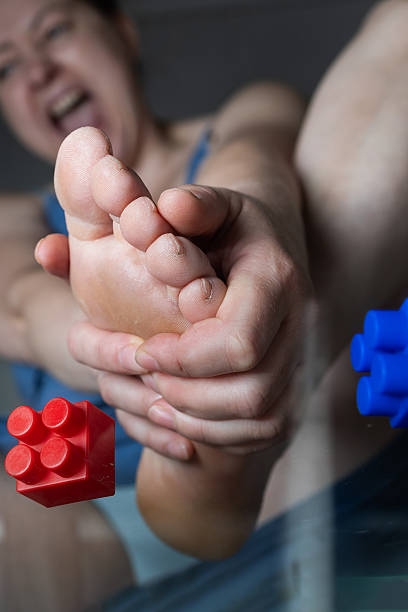 Constructor Experiences Foot Pain While Handling Toys at Home With a Child