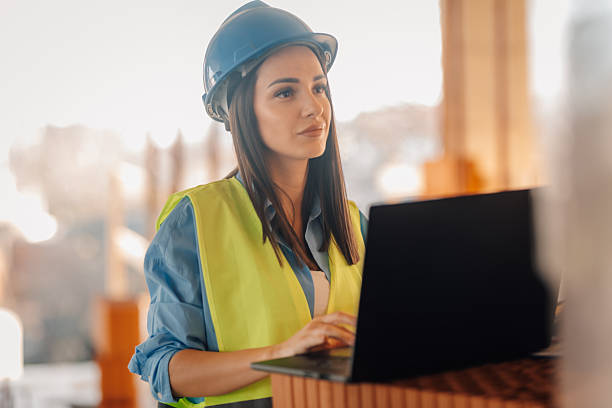 istock Female architect working on laptop at construction site 2223185600